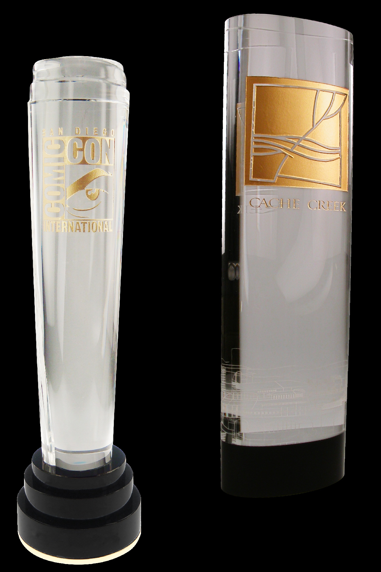 custom crystal awards made by adding color filled logos and text on the surface of the crystal. The trophies shown are the of the Comic Con award and a custom award for Cache Creek